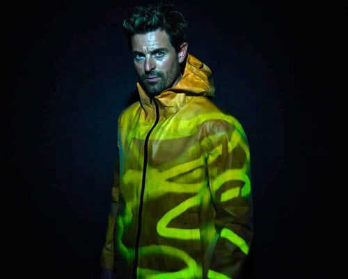 vollebak’s new color-shifting 'firefly' jacket glows in orange by day and yellow-green at night